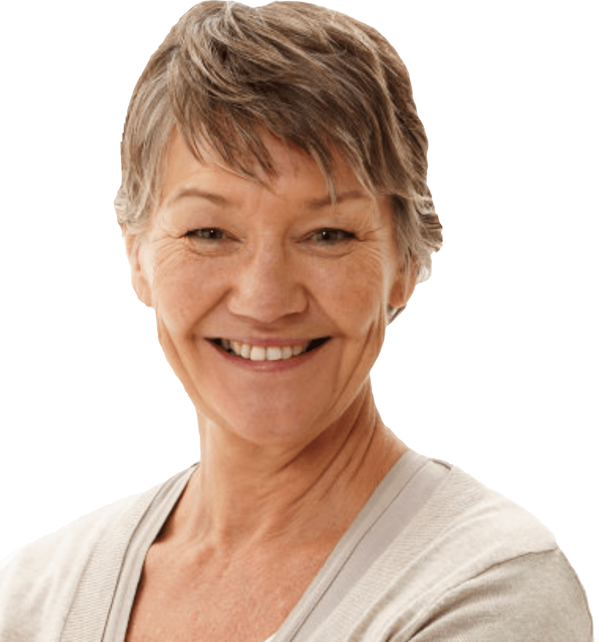 A smiling older woman with short, gray hair is looking directly at the camera. She is wearing a light-colored top and stands against a plain green background.
